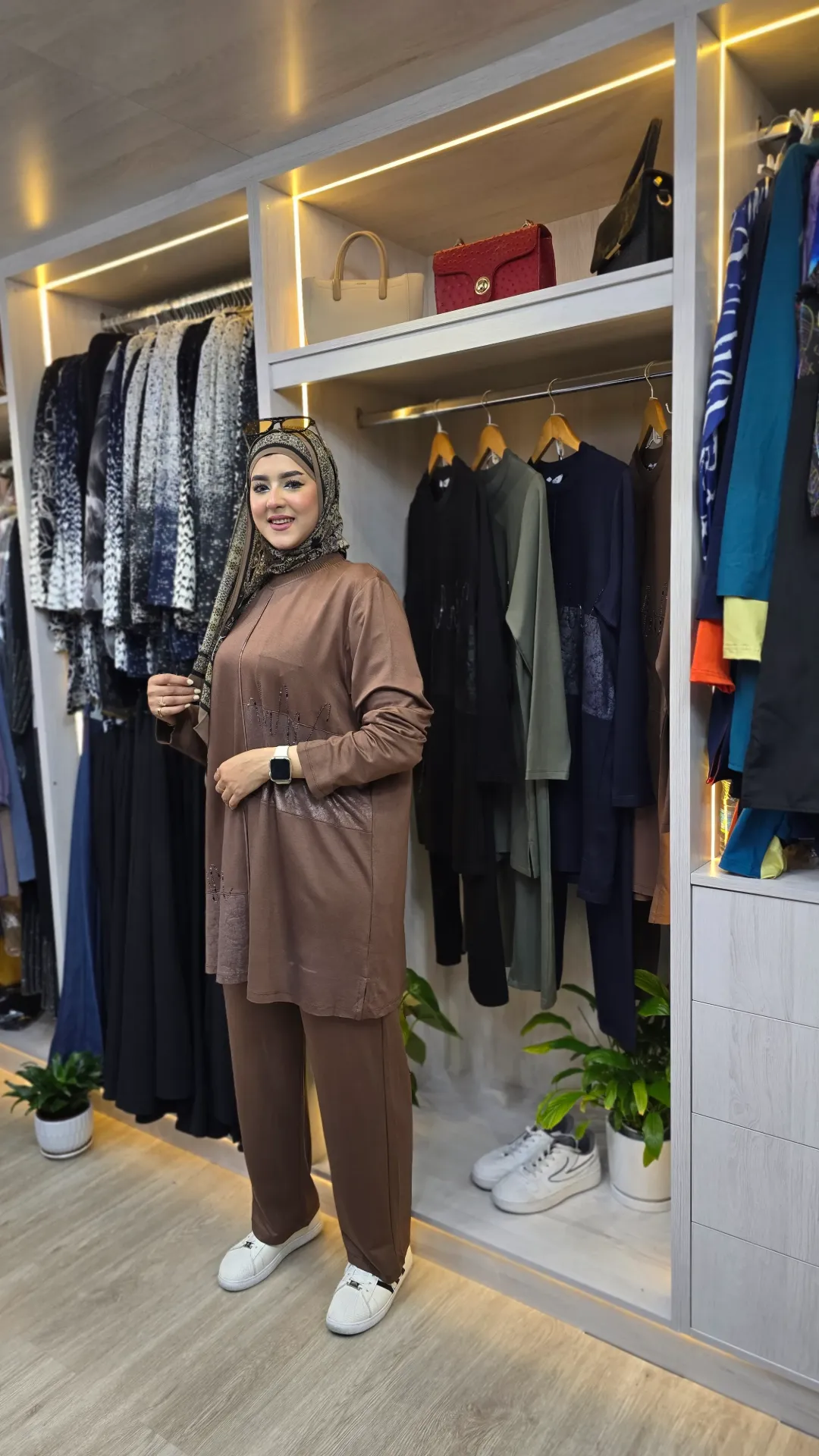 Track suit with strap on the chest